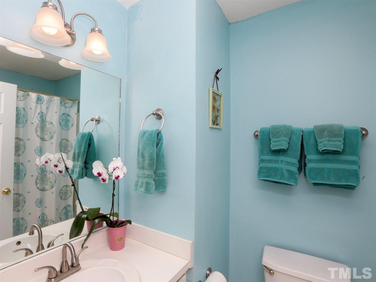 4604 Drewbridge Way Raleigh, NC 27604 - Photo 20 of 24 a bathroom with a sink mirror and vanity
