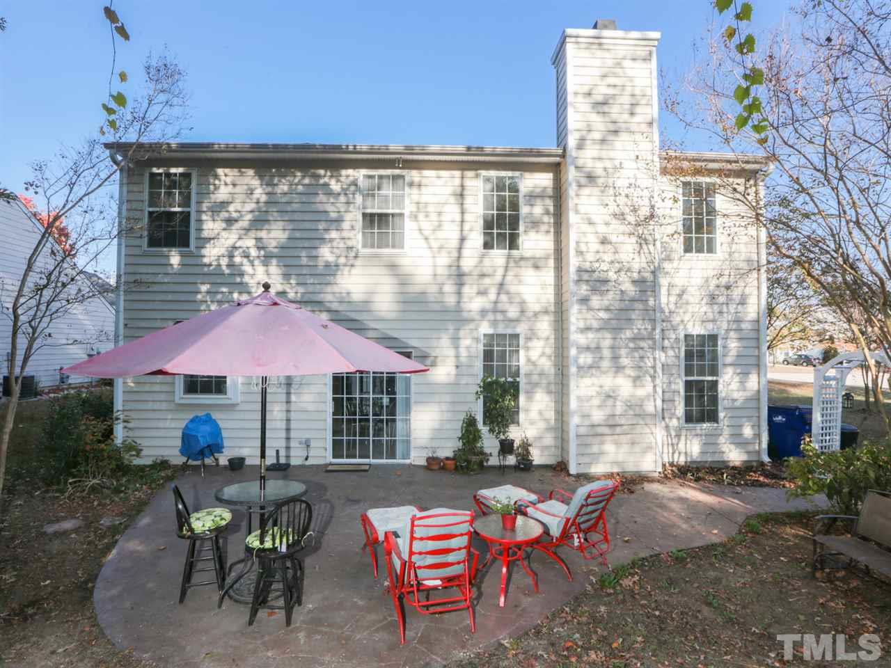 4604 Drewbridge Way Raleigh, NC 27604 - Photo 23 of 24 a view of a patio with couches table and chairs under an umbrella