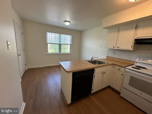 a kitchen with sink and cabinets