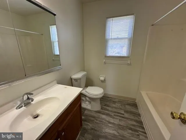 a bathroom with a sink toilet and tub