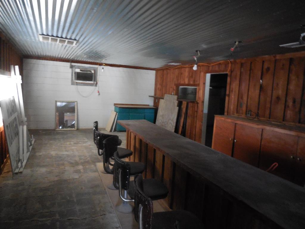 605 East Loop 254 Ranger, TX 76470 - Photo 8 of 21 a workspace with furniture and wooden walls