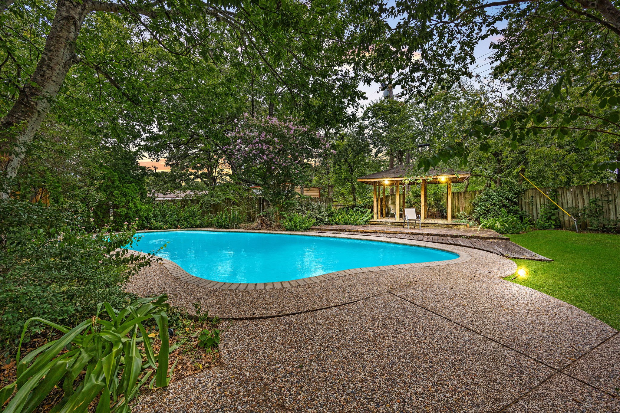 a view of a swimming pool with a yard