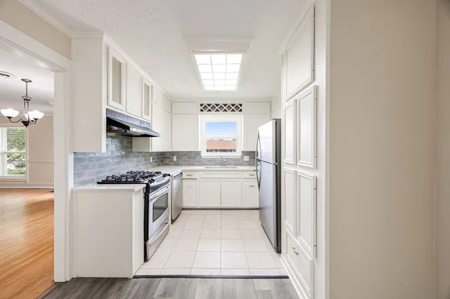 a kitchen with stainless steel appliances granite countertop a stove and a refrigerator