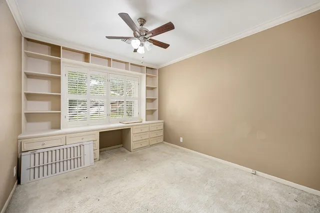 an empty room with a chandelier fan and a ceiling fan