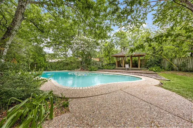 a backyard of a house with yard and outdoor seating