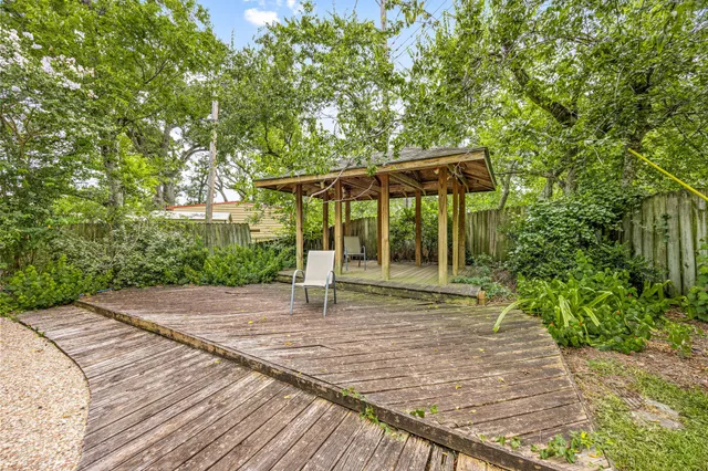 a view of a yard with plants and trees