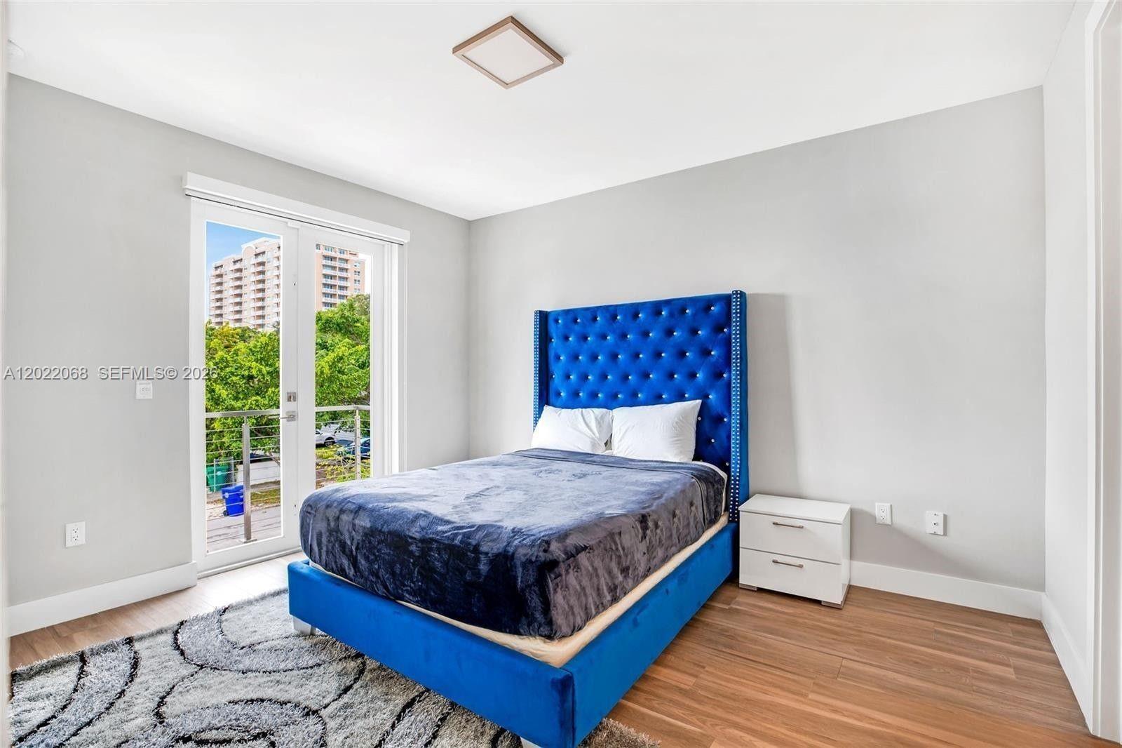 3657 Southwest 26th Street Miami, FL 33133 - Photo 8 of 12 a bedroom with a bed and window