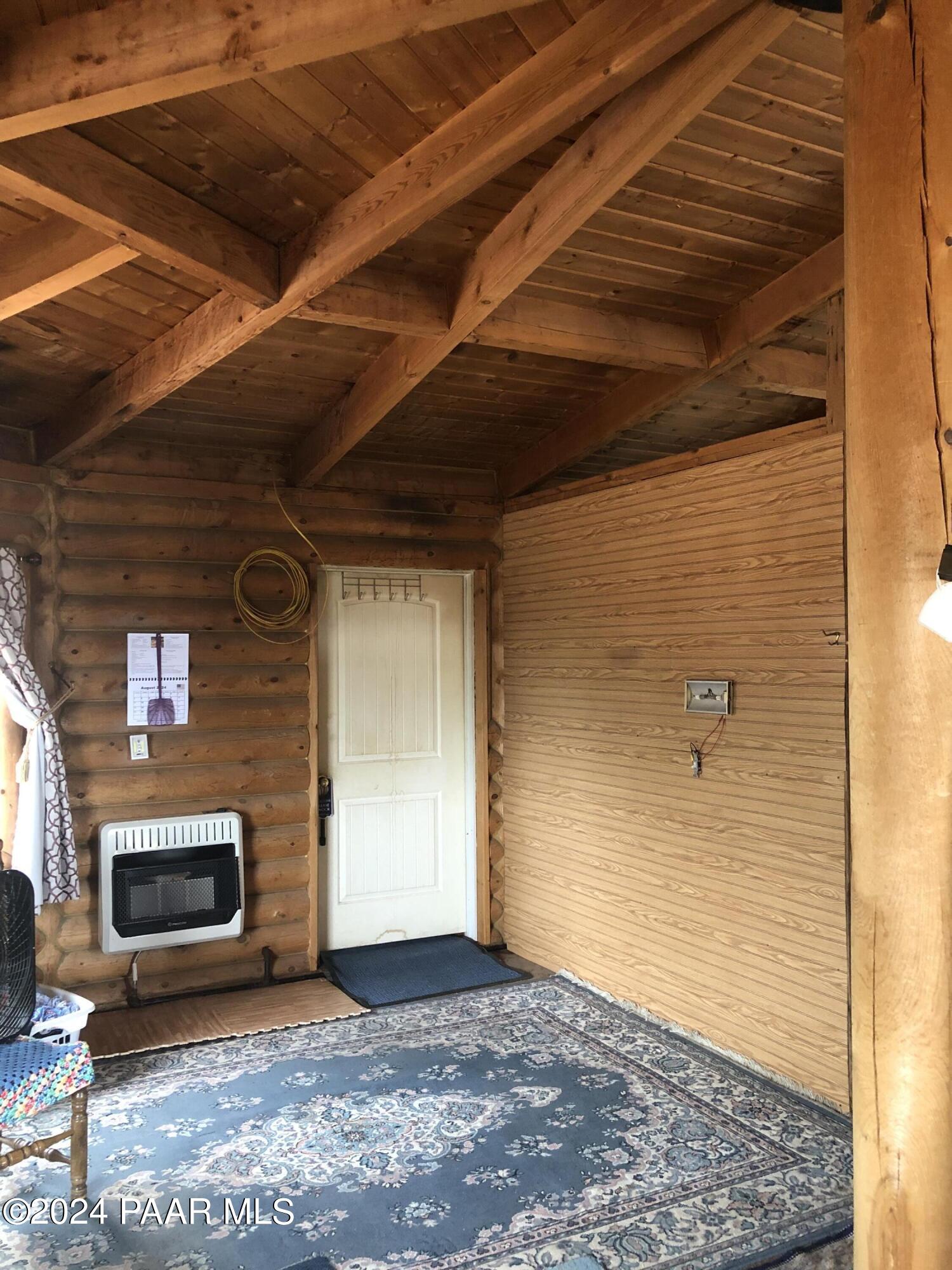 56539 El Parque Circle Seligman, AZ 86337 - Photo 11 of 37 a view of an empty room with wooden floor and a fireplace