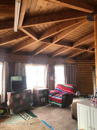 a living room with furniture a flat screen tv and outdoor view