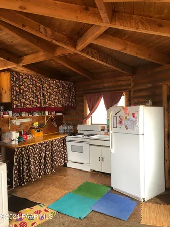 a kitchen with stainless steel appliances granite countertop a refrigerator and a stove