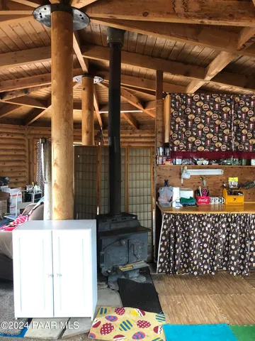 a view of an empty room with a fireplace and a window