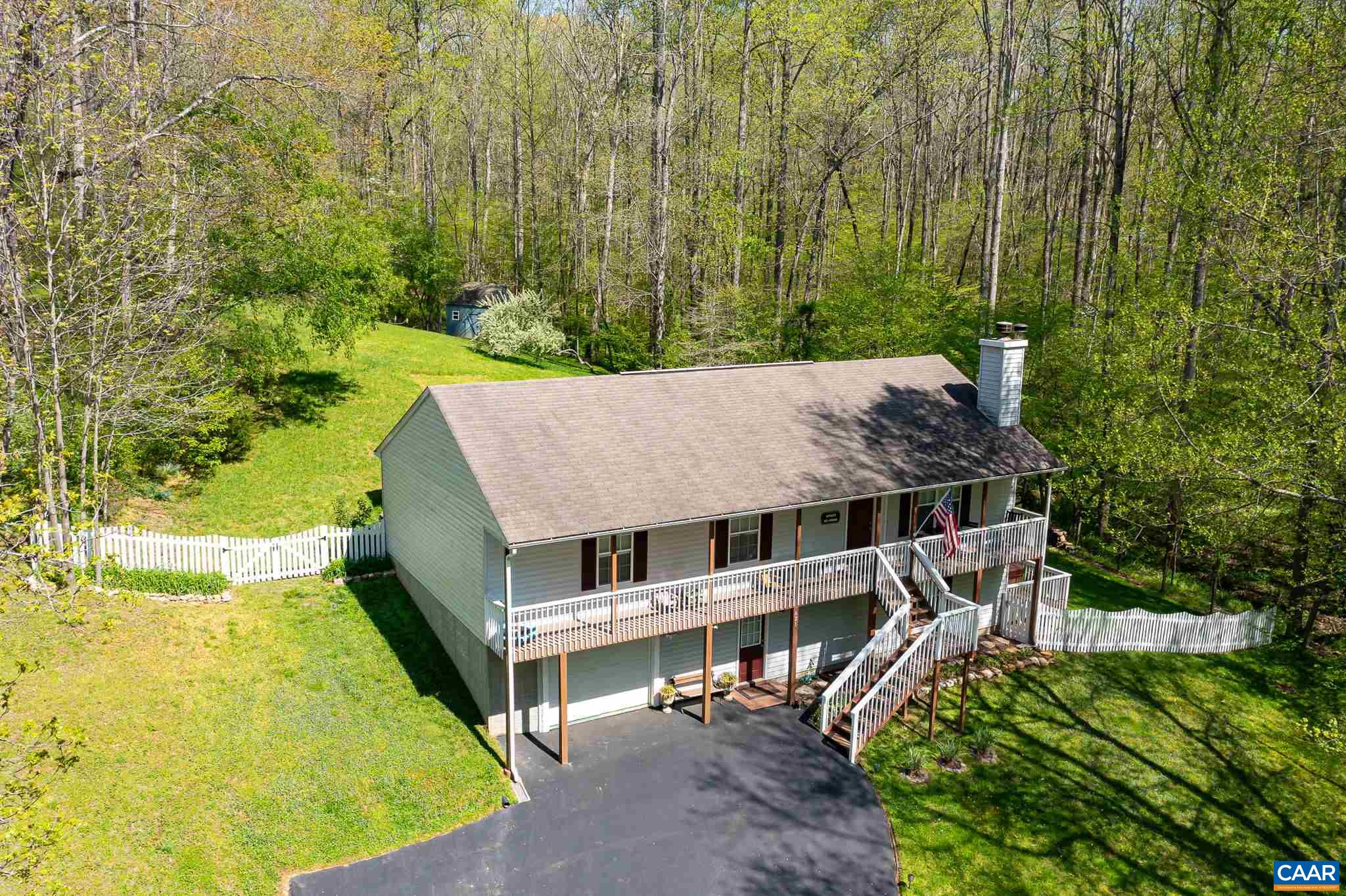 621 Jonquil Road Ruckersville, VA 22968 - Photo 54 of 64 an aerial view of a house with a yard table and chairs