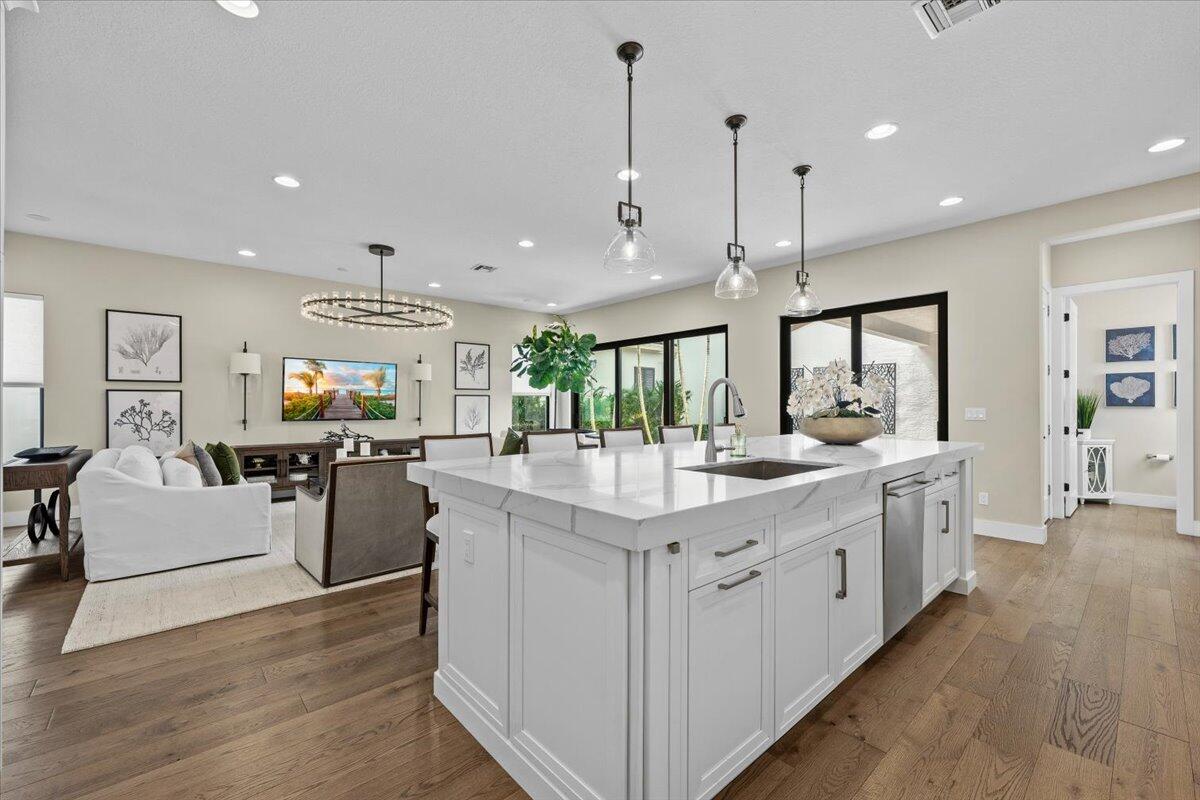 13237 Alton Road Palm Beach Gardens, FL 33418 - Photo 13 of 51 a kitchen with stainless steel appliances granite countertop a lot of counter space and wooden floors