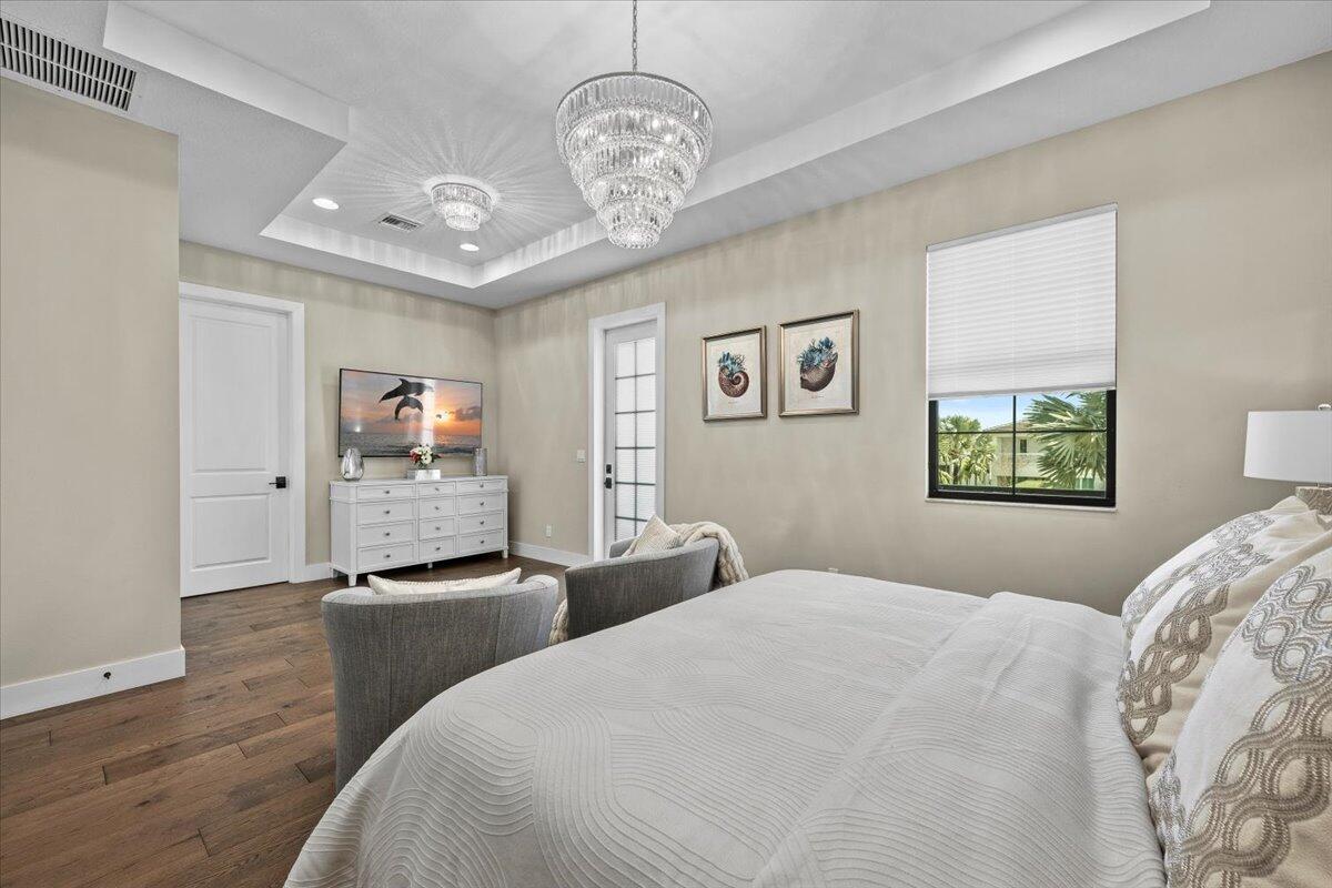 13237 Alton Road Palm Beach Gardens, FL 33418 - Photo 18 of 51 a bedroom with bed and window