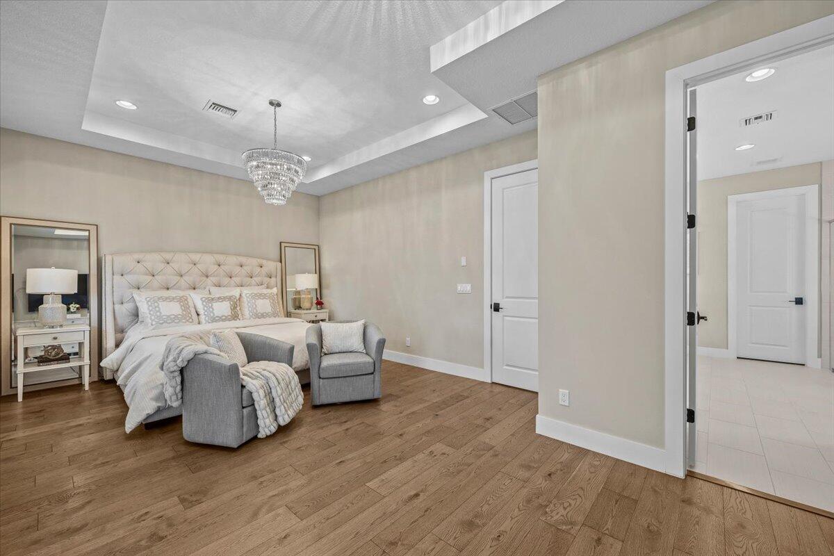 13237 Alton Road Palm Beach Gardens, FL 33418 - Photo 19 of 51 a spacious bedroom with a bed and closet