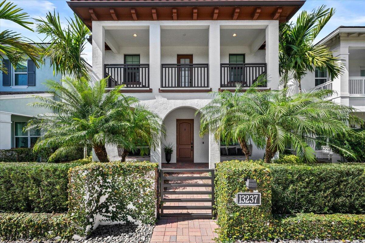 13237 Alton Road Palm Beach Gardens, FL 33418 - Photo 2 of 51 a front view of a house with a garden
