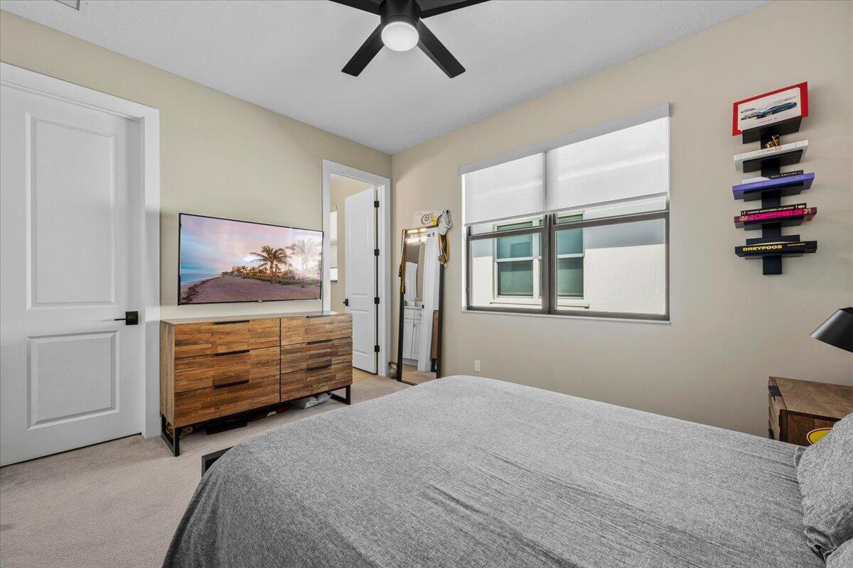 13237 Alton Road Palm Beach Gardens, FL 33418 - Photo 24 of 51 a bedroom with a bed and a window