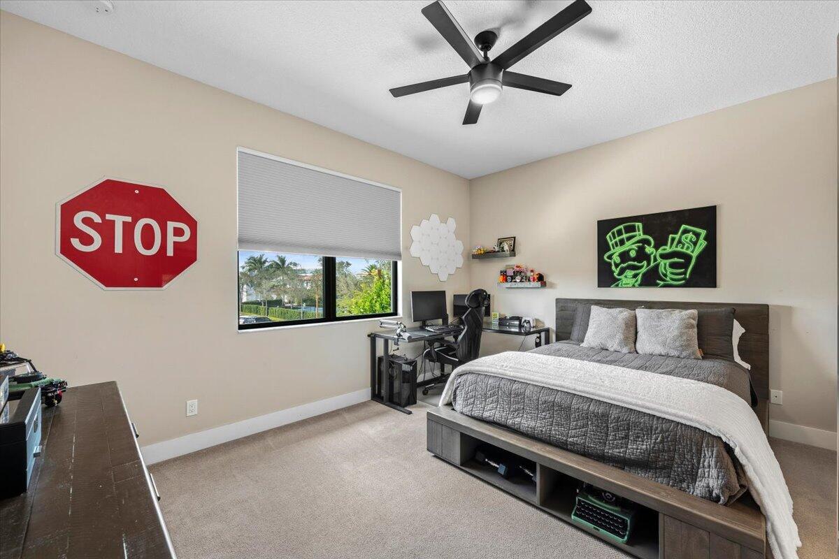 13237 Alton Road Palm Beach Gardens, FL 33418 - Photo 26 of 51 a bedroom with a bed and a chandelier