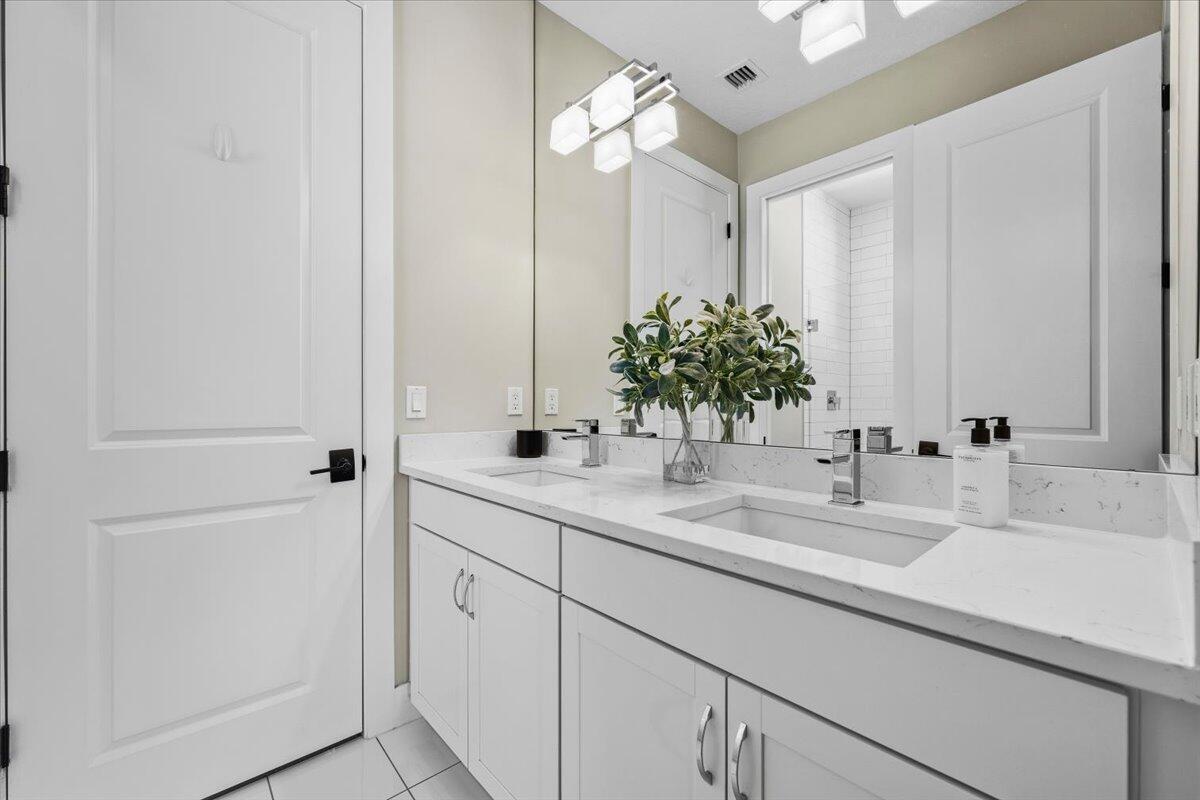 13237 Alton Road Palm Beach Gardens, FL 33418 - Photo 27 of 51 a bathroom with a sink and a mirror