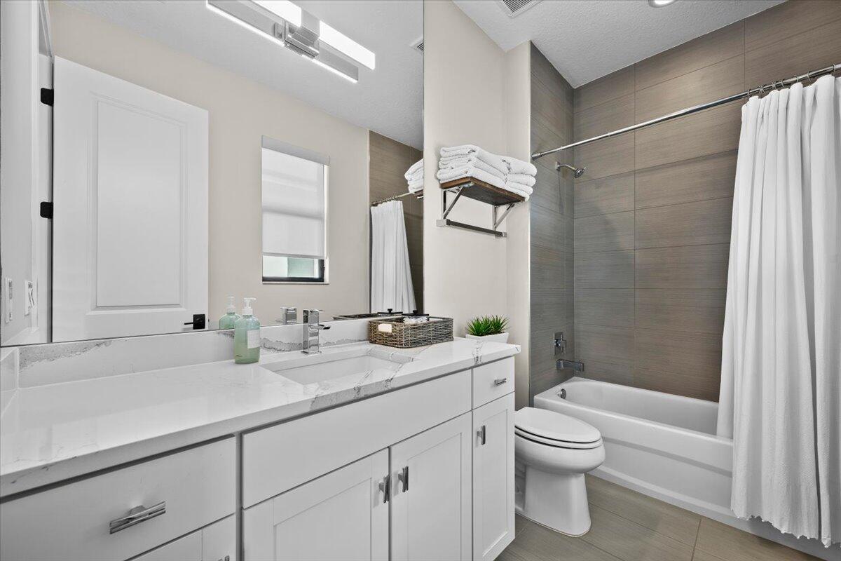 13237 Alton Road Palm Beach Gardens, FL 33418 - Photo 29 of 51 a bathroom with a sink a toilet and shower