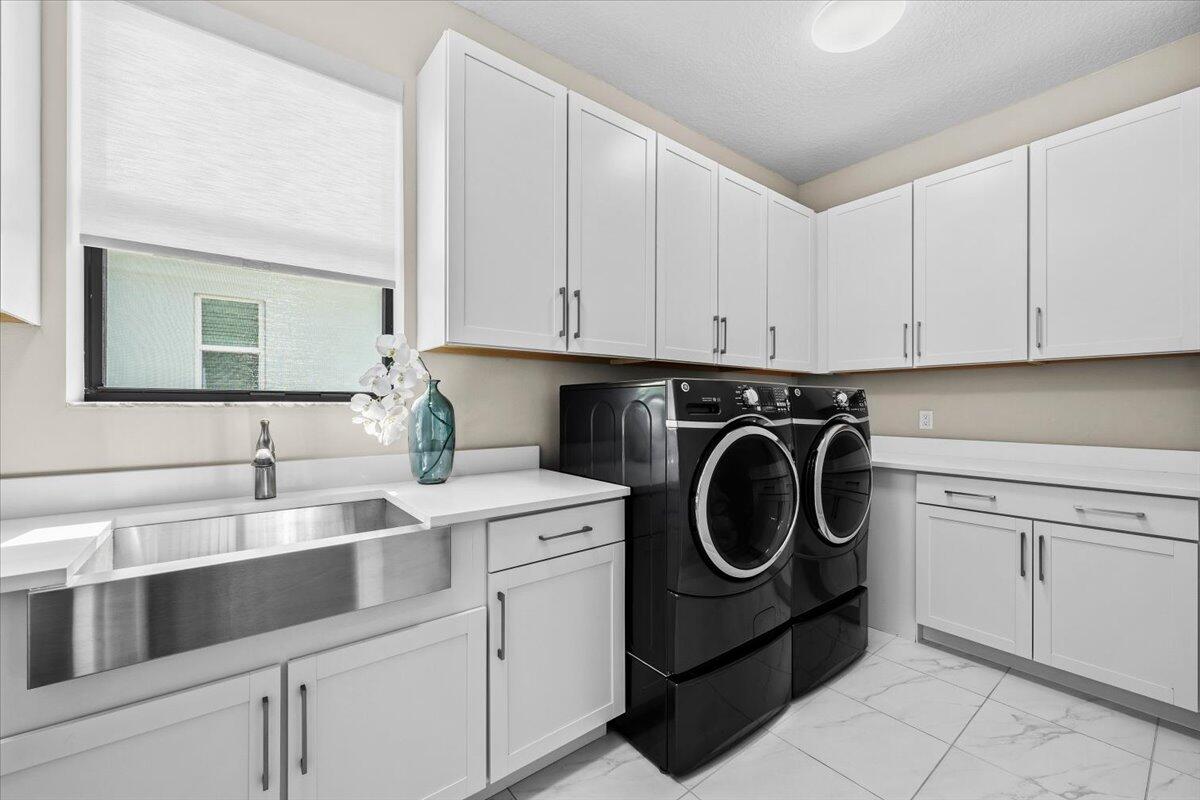 13237 Alton Road Palm Beach Gardens, FL 33418 - Photo 30 of 51 a utility room with sink dryer and washer
