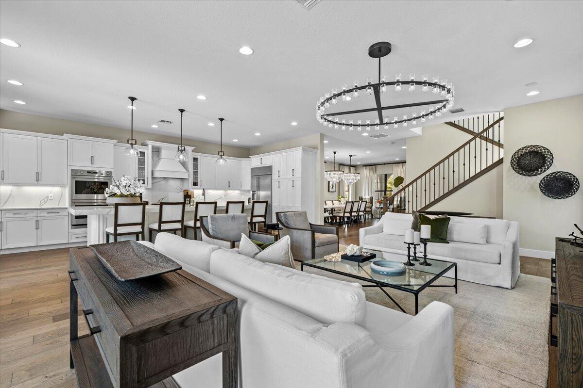 13237 Alton Road Palm Beach Gardens, FL 33418 - Photo 3 of 51 a living room with furniture kitchen view and a chandelier