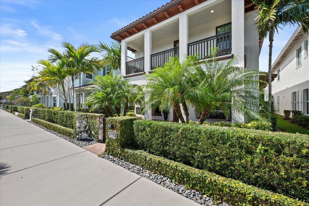 13237 Alton Road Palm Beach Gardens, FL 33418 - Photo 4 of 51 a front view of a house with a yard