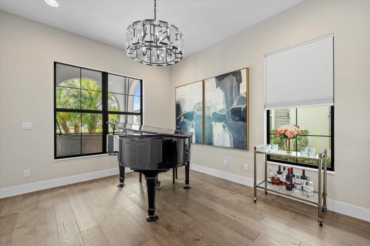 13237 Alton Road Palm Beach Gardens, FL 33418 - Photo 8 of 51 a living room with furniture and a chandelier