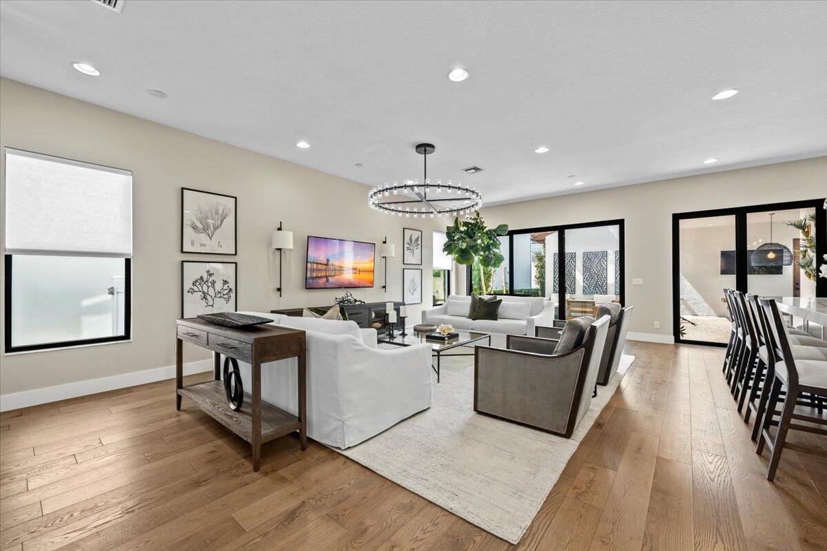 13237 Alton Road Palm Beach Gardens, FL 33418 - Photo 10 of 51 a living room with fireplace furniture and a wooden floor