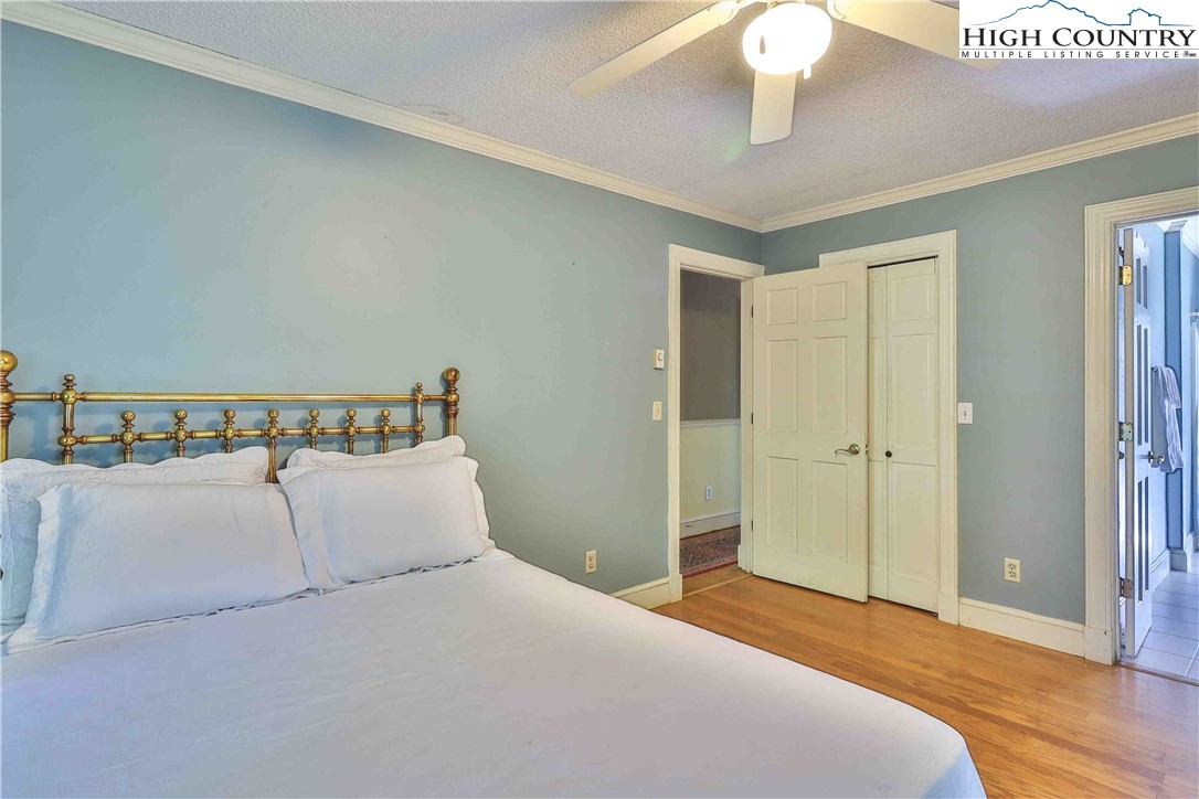 5033 Junaluska Road Boone, NC 28607 - Photo 12 of 34 a bedroom with a large bed and a chandelier