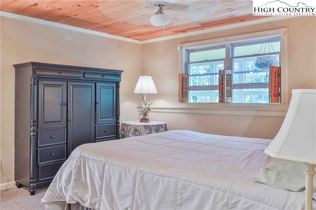 5033 Junaluska Road Boone, NC 28607 - Photo 19 of 34 a bedroom with a bed and a large window