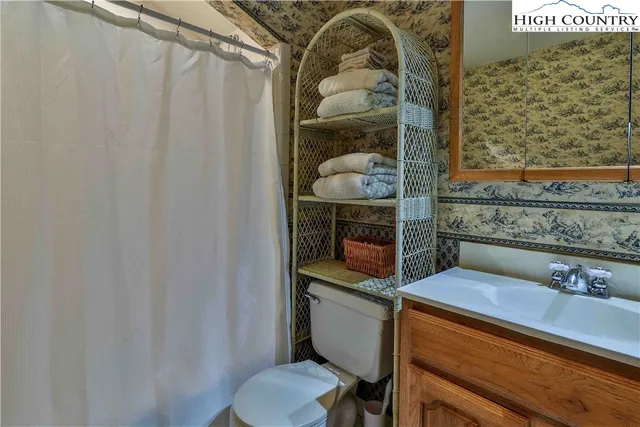 a white toilet sitting next to a bathroom sink