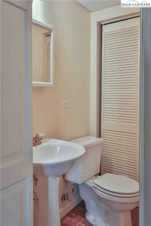 5033 Junaluska Road Boone, NC 28607 - Photo 22 of 34 a white toilet sitting next to a bathroom sink