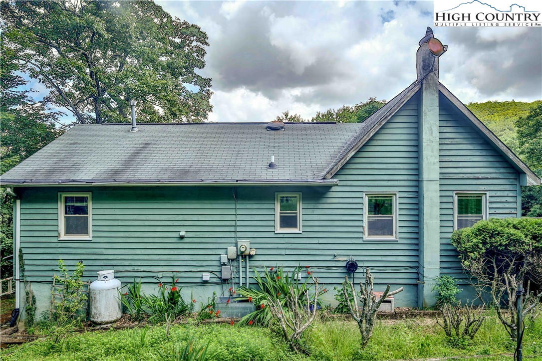 5033 Junaluska Road Boone, NC 28607 - Photo 29 of 34 a view of a house with a yard and plants
