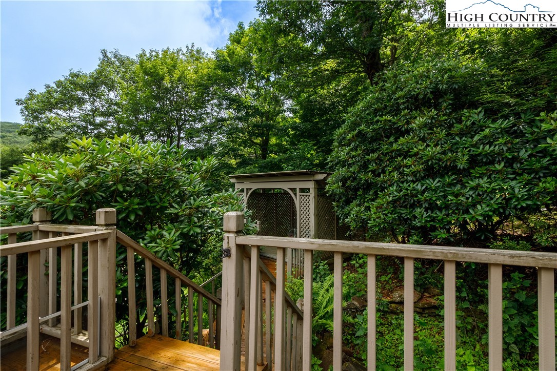 5033 Junaluska Road Boone, NC 28607 - Photo 32 of 34 a balcony with wooden floor and yard in the back