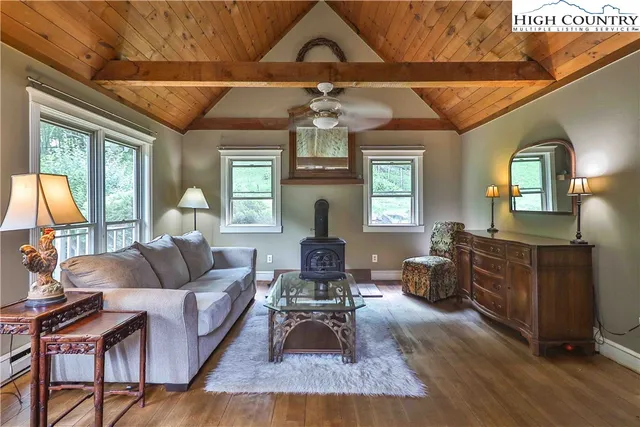 a living room with furniture a fireplace and a chandelier