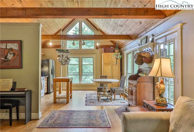 a living room with furniture a large window with wooden floor