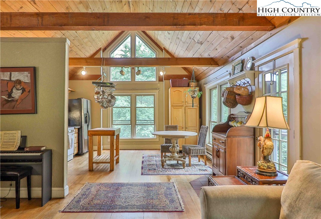 5033 Junaluska Road Boone, NC 28607 - Photo 6 of 34 a living room with furniture a large window with wooden floor