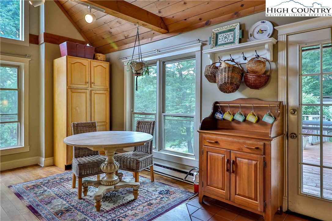 5033 Junaluska Road Boone, NC 28607 - Photo 8 of 34 a dining room with a fireplace and a table