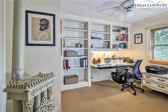 a view of a workspace with furniture and a workspace