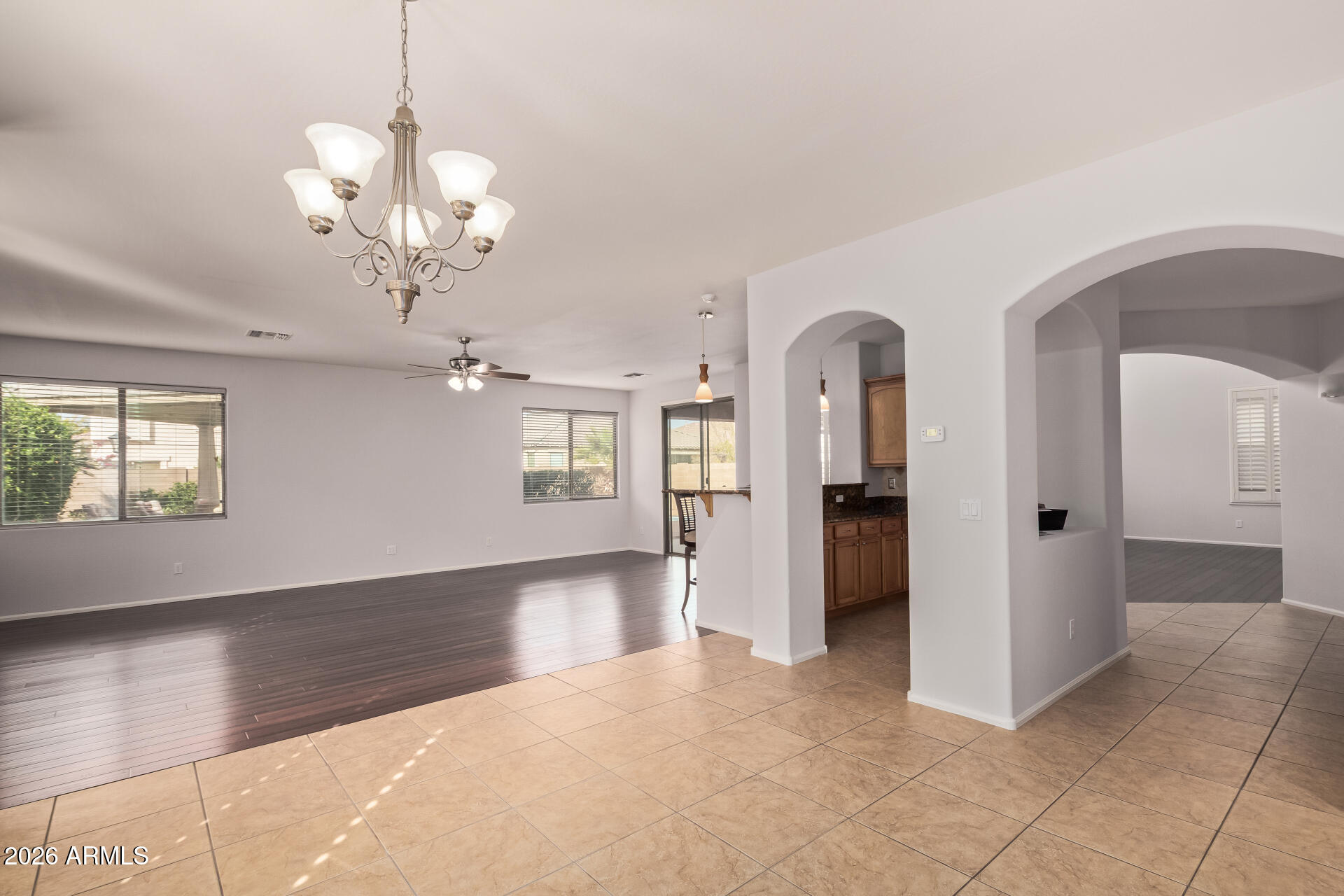 41106 West Coltin Way Maricopa, AZ 85138 - Photo 11 of 51 an empty room with wooden floor and windows