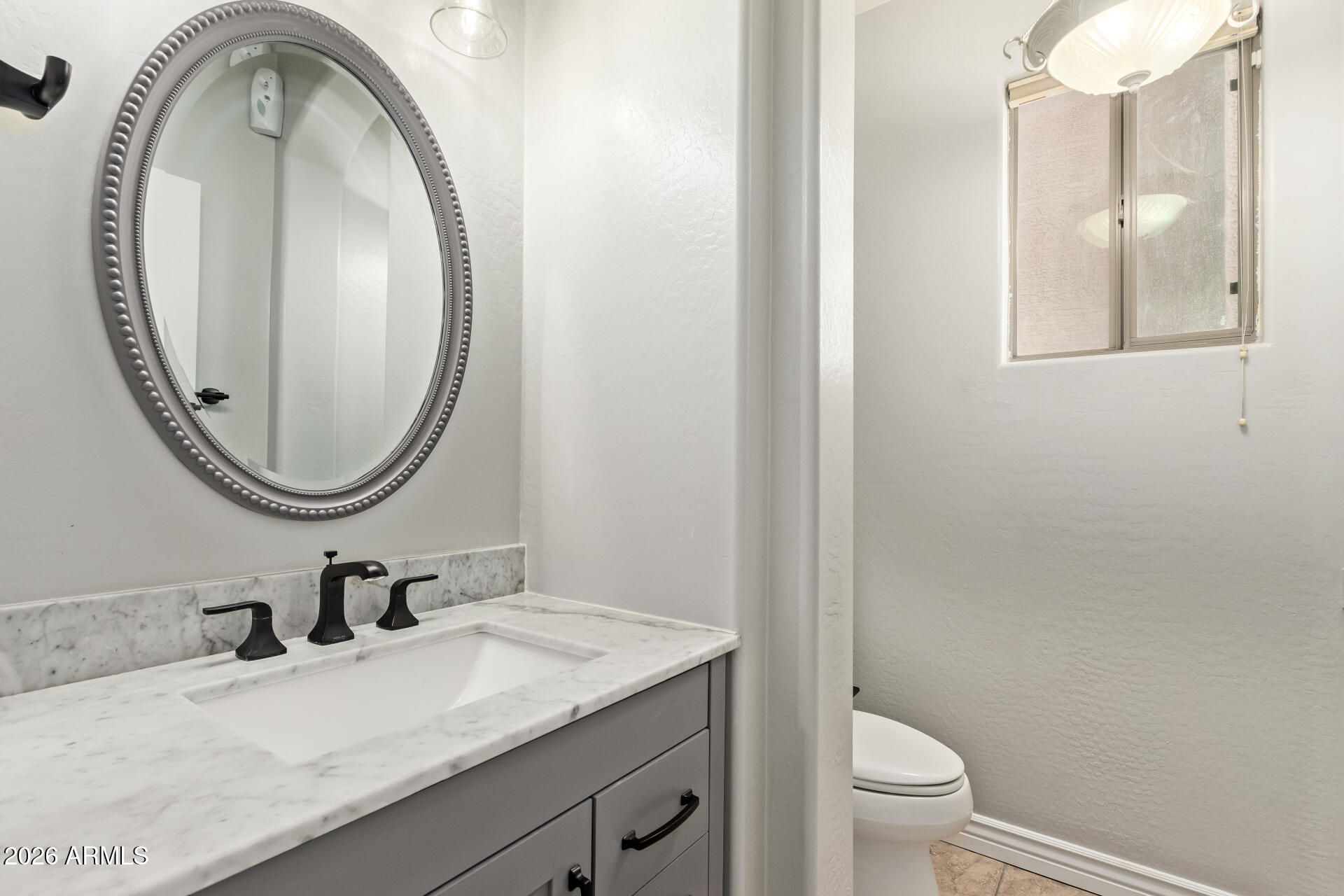 41106 West Coltin Way Maricopa, AZ 85138 - Photo 18 of 51 a bathroom with a granite countertop sink a toilet and a mirror