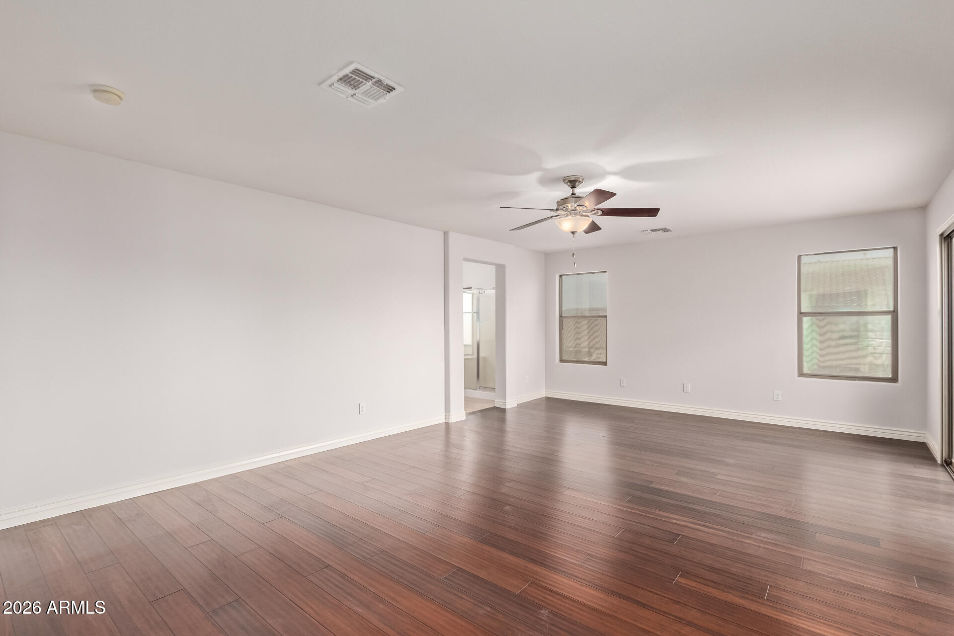 41106 West Coltin Way Maricopa, AZ 85138 - Photo 23 of 51 a view of an empty room with wooden floor and a window