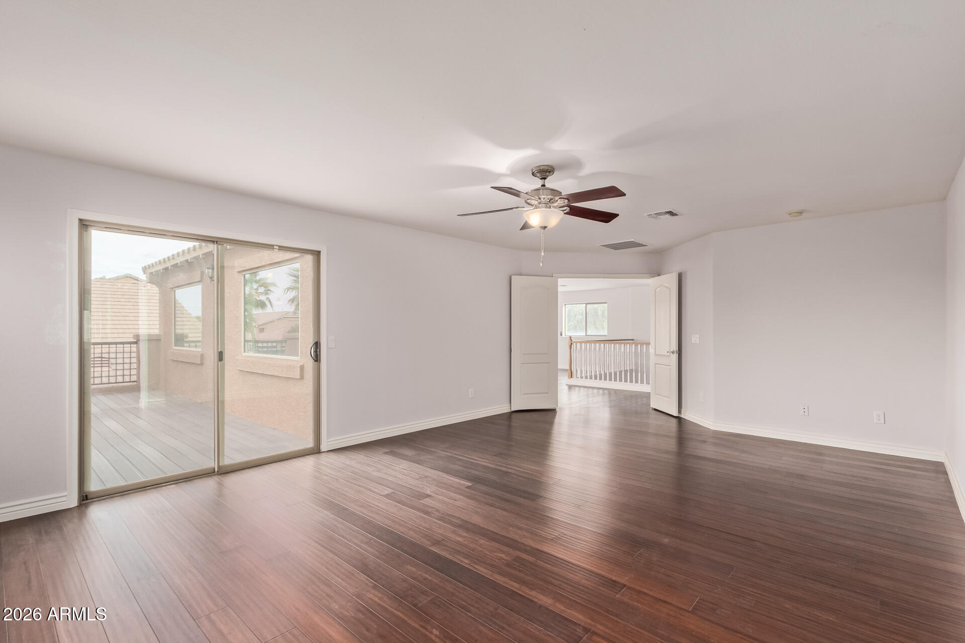 41106 West Coltin Way Maricopa, AZ 85138 - Photo 25 of 51 a view of an empty room with wooden floor and a window