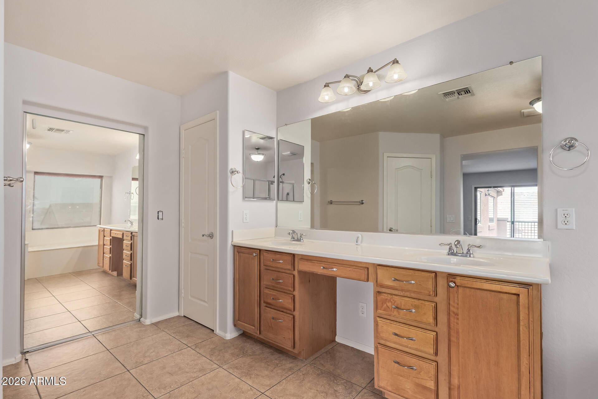 41106 West Coltin Way Maricopa, AZ 85138 - Photo 27 of 51 a spacious bathroom with a granite countertop sink mirror and double