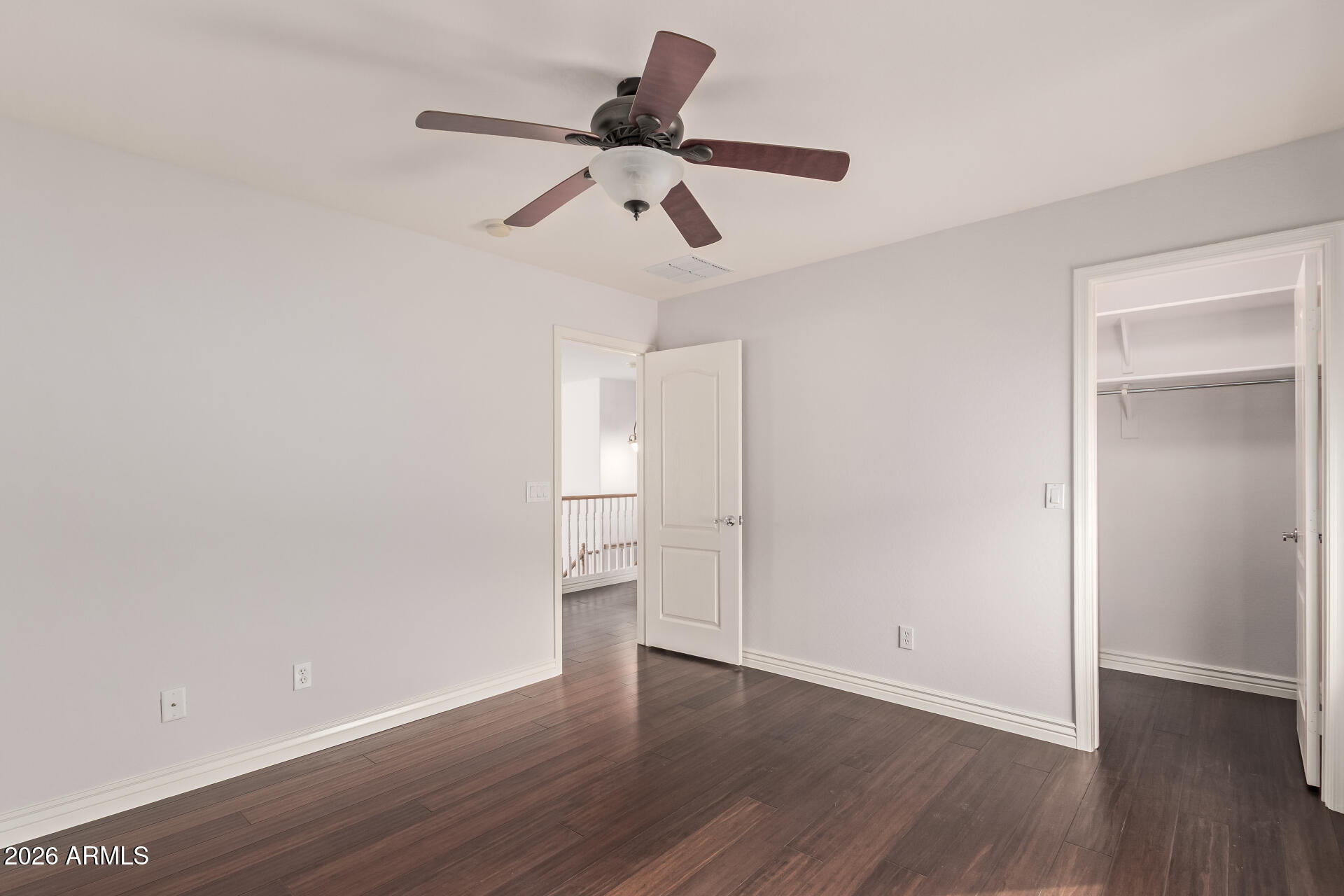 41106 West Coltin Way Maricopa, AZ 85138 - Photo 30 of 51 a view of empty room with wooden floor and ceiling fan