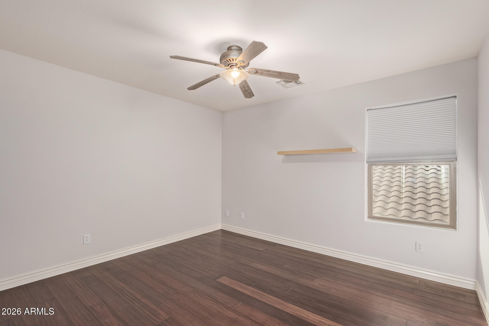 41106 West Coltin Way Maricopa, AZ 85138 - Photo 31 of 51 an empty room with wooden floor fan and windows