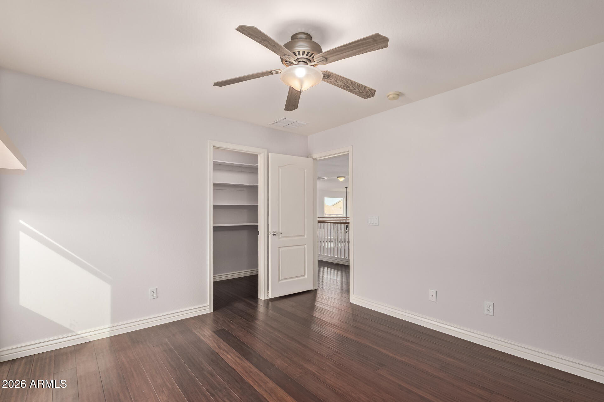 41106 West Coltin Way Maricopa, AZ 85138 - Photo 32 of 51 a view of an empty room with a window and wooden floor
