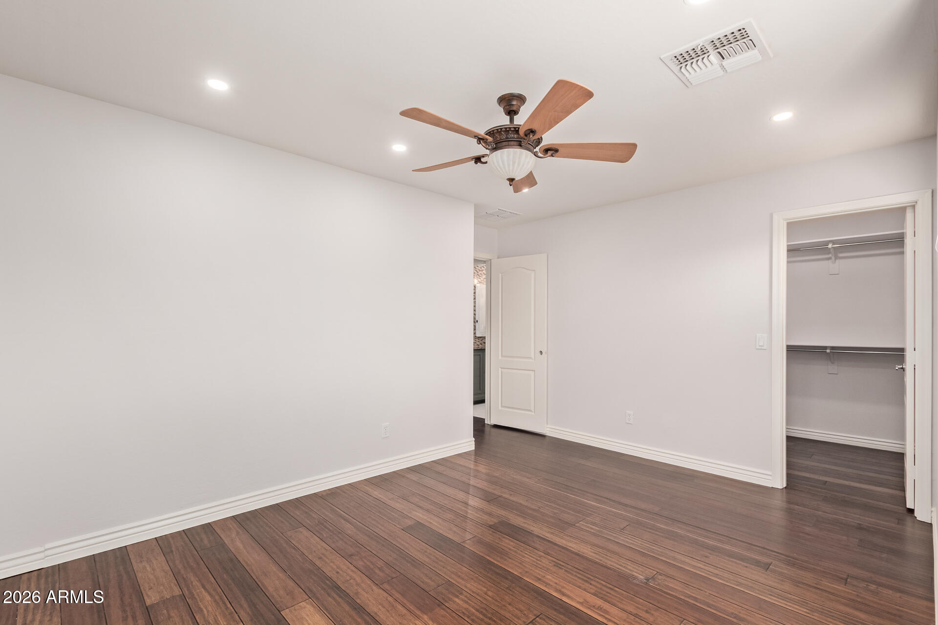 41106 West Coltin Way Maricopa, AZ 85138 - Photo 34 of 51 an empty room with wooden floor fan and windows