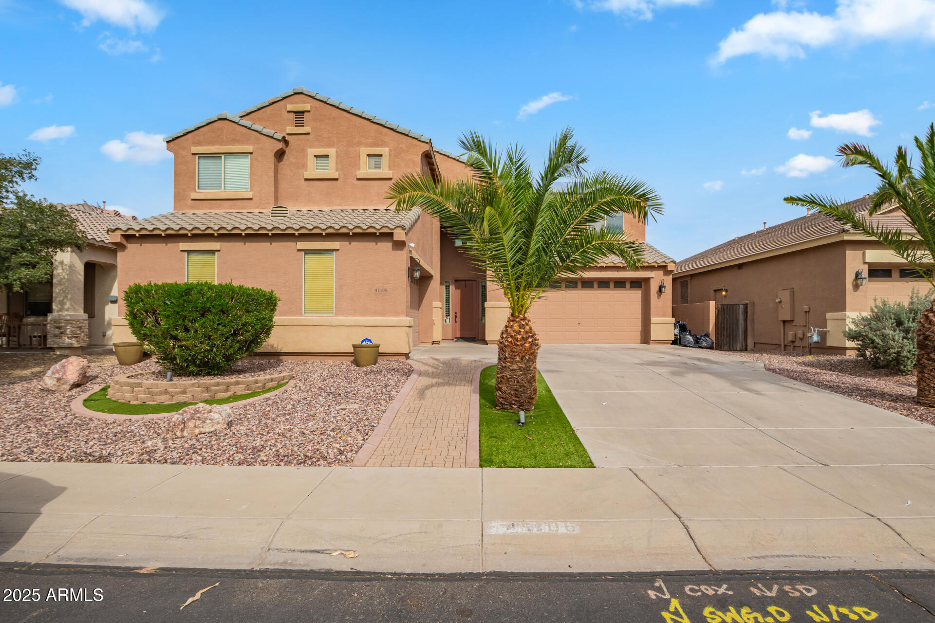 41106 West Coltin Way Maricopa, AZ 85138 - Photo 49 of 51 a front view of a house with a yard and garage